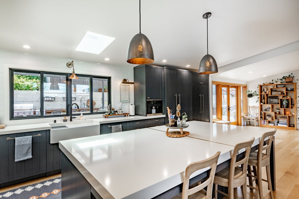 Open-concept kitchen with a large central marble island